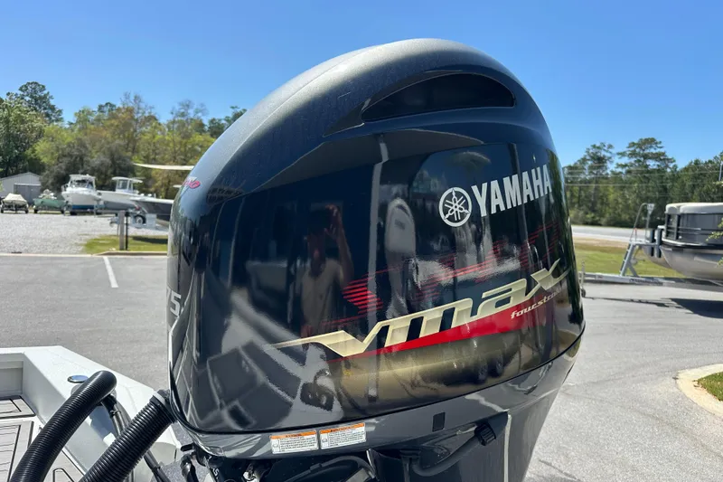 Slide: The Image of Yamaha VMAX outboard motor on 2024 Avid 23 Mag boat, parked outdoors. - 3