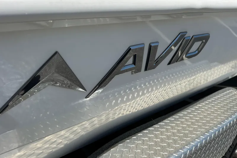 Slide: The Image of Close-up of 2024 Avid 23 Mag logo on a sleek white surface. - 6