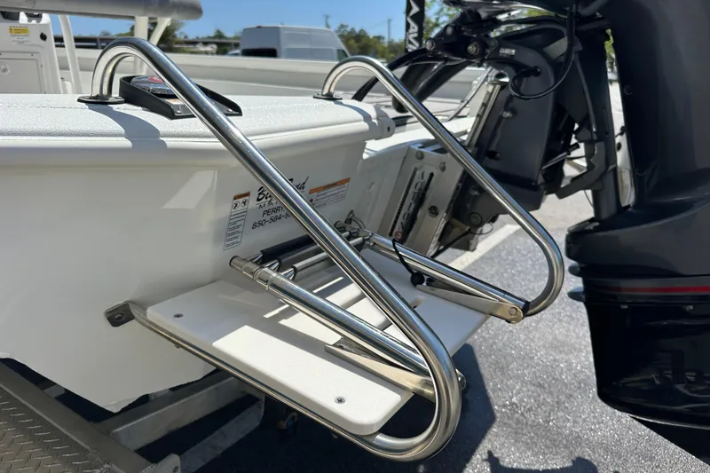 Slide: The Image of 2024 Avid 23 Mag boat with stainless steel swim ladder and outboard motor. - 7