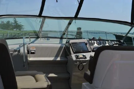 Slide: The Image of 2017 Sea Ray Sundancer 370 helm with modern controls and panoramic view. - 14