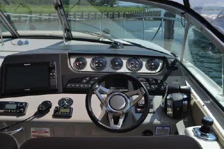 Slide: The Image of Cockpit of 2017 Sea Ray Sundancer 370 with modern navigation instruments and steering wheel. - 15