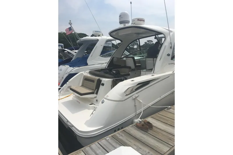Slide: The Image of 2017 Sea Ray Sundancer 370 yacht docked, showcasing sleek design and spacious seating. - 8