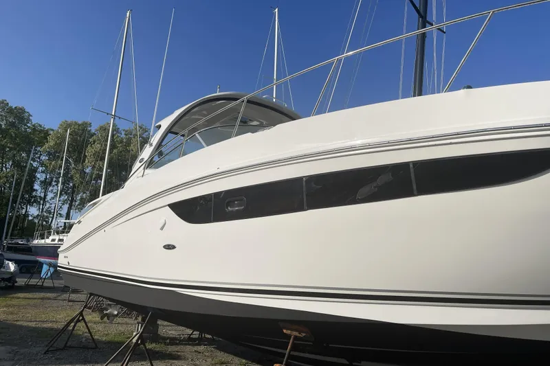 Slide: The Image of 2017 Sea Ray Sundancer 370 yacht on dry dock under clear blue sky. - 10
