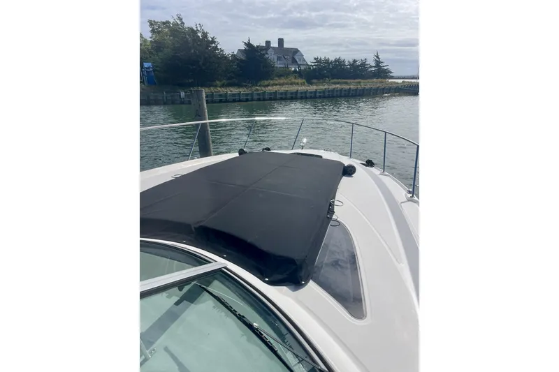 Slide: The Image of 2017 Sea Ray Sundancer 370 yacht docked by a waterfront house. - 11