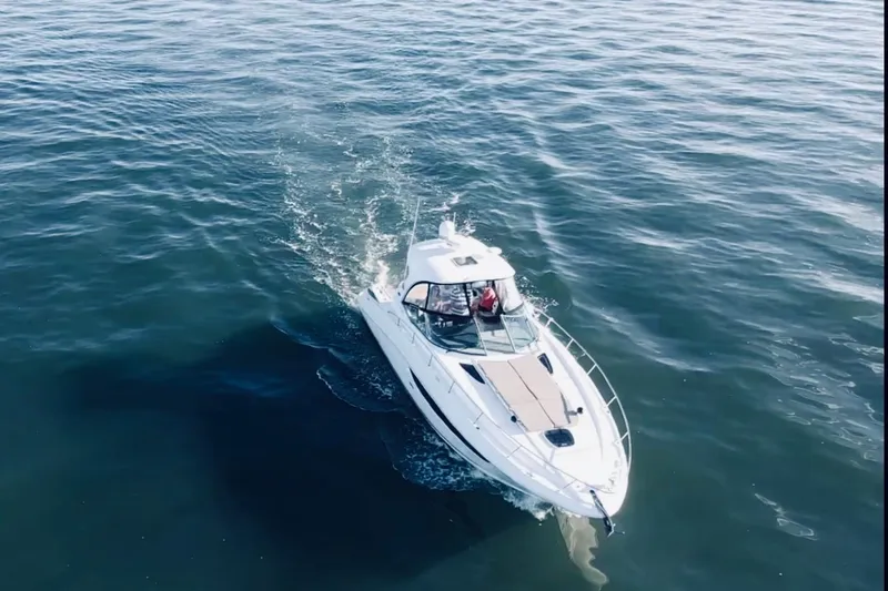 Slide: The Image of 2017 Sea Ray Sundancer 370 cruising on open water, aerial view. - 4