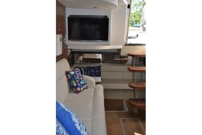 Slide: The Image of Interior of 2017 Sea Ray Sundancer 370 yacht with sofa, TV, and wooden stairs. - 24