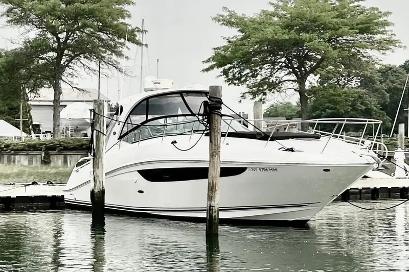 Slide: The Image of 2017 Sea Ray Sundancer 370 yacht docked at a marina with trees in the background. - 5