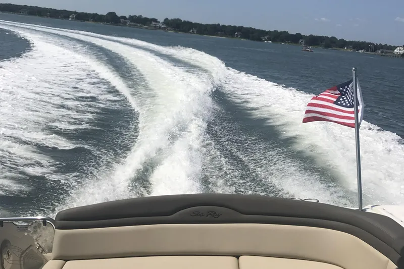 Slide: The Image of 2017 Sea Ray Sundancer 370 cruising with American flag, leaving a wake on a sunny day. - 12