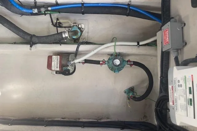 Slide: The Image of Engine compartment of a 2017 Sea Ray Sundancer 370 with visible hoses and wiring. - 31