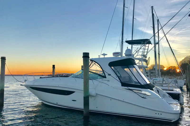 Slide: The Image of 2017 Sea Ray Sundancer 370 yacht docked at sunset, serene marina setting. - 3