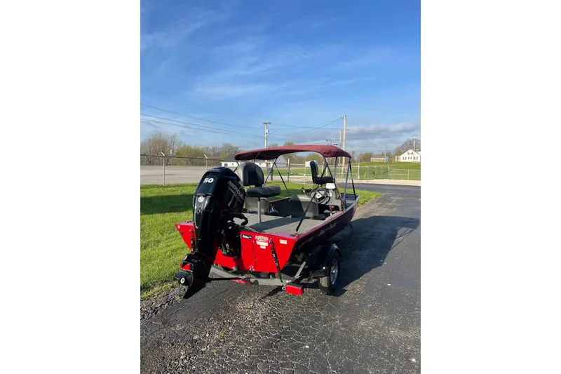 Slide: The Image of 2023 Tracker Bass Tracker Classic XL boat with outboard motor on a sunny day. - 4