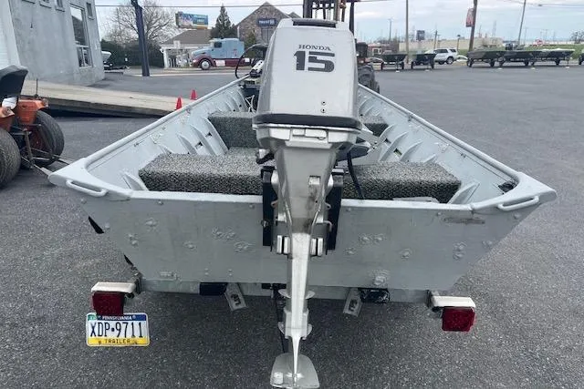 Slide: The Image of 1980 Lowe Big Jon 16 boat with Honda 15 outboard motor on trailer. - 2