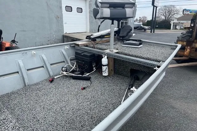 Slide: The Image of 1980 Lowe Big Jon 16 boat with carpeted deck and mounted seat. - 5