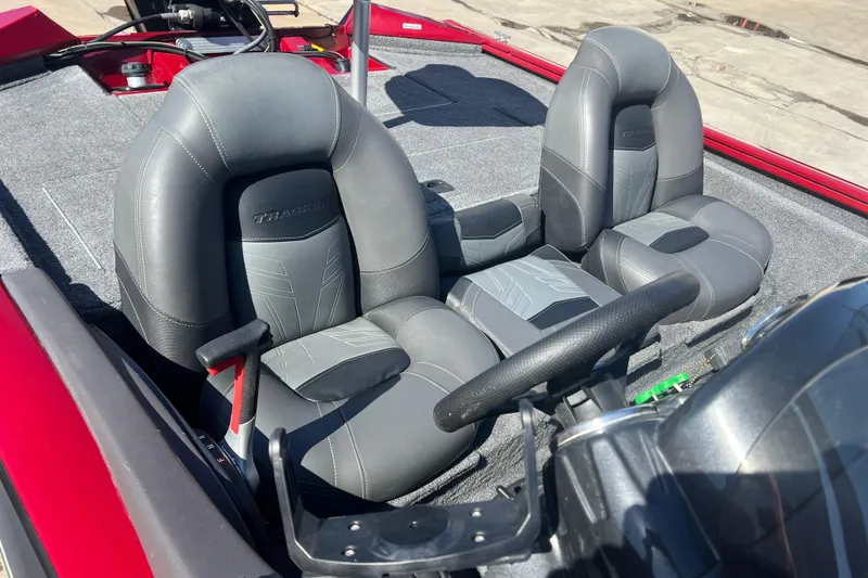 Slide: The Image of 2020 Tracker Pro Team 175 TXW boat interior with gray seats and steering wheel. - 10
