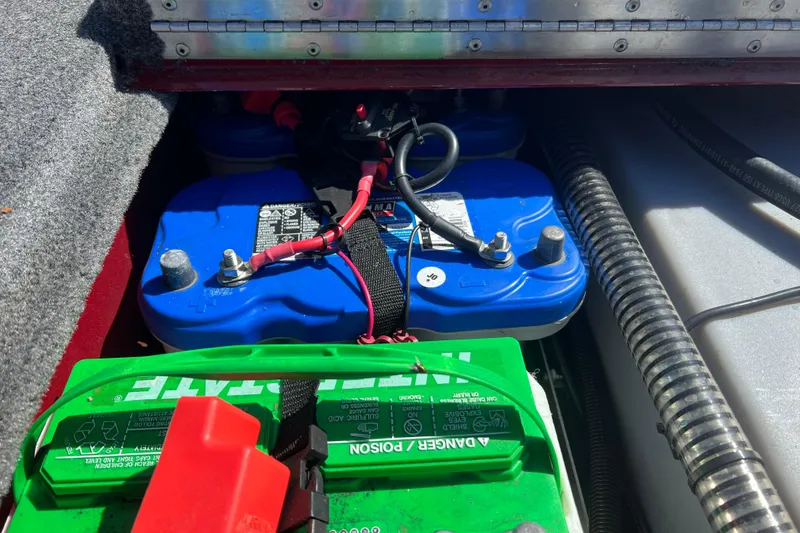 Slide: The Image of 2020 Tracker Pro Team 175 TXW boat battery compartment with blue and green batteries. - 13
