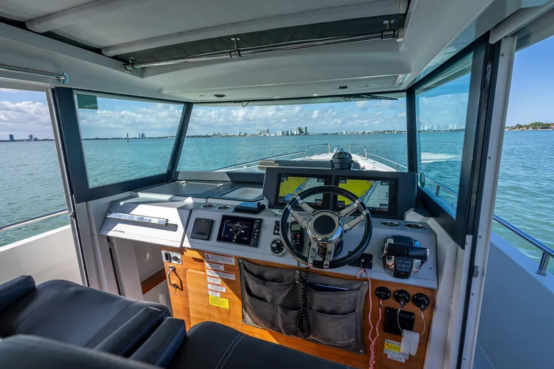 Slide: The Image of Interior view of 2017 Axopar 37 XC Cross Cabin boat cockpit with navigation equipment. - 10