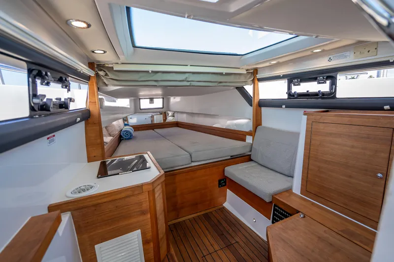 Slide: The Image of Interior of 2017 Axopar 37 XC Cross Cabin with wood accents and skylight. - 14