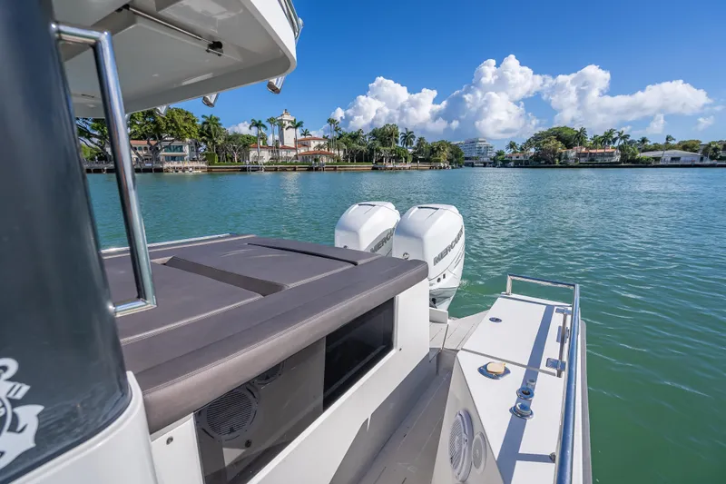 Slide: The Image of Axopar 37 XC Cross Cabin 2017 on serene water with scenic shoreline view. - 18