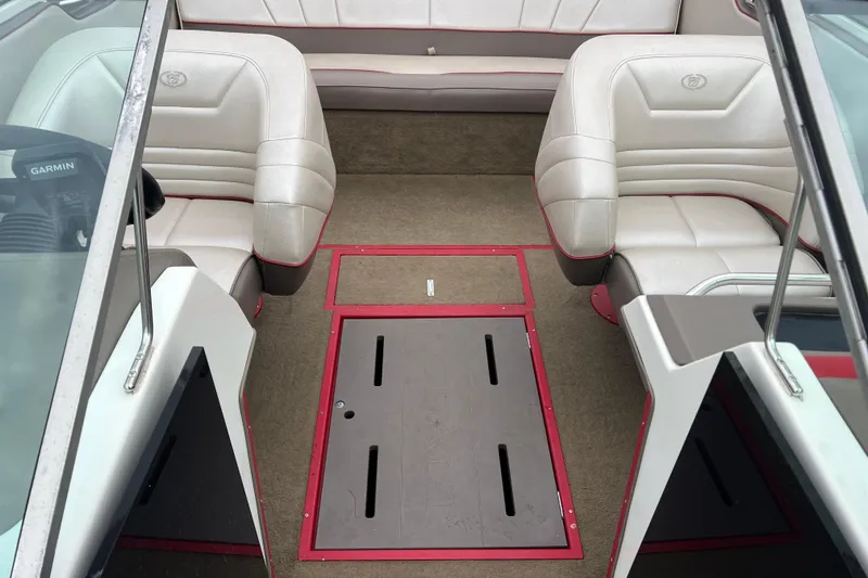 Slide: The Image of Interior of a 1996 Cobalt 220 boat with white seating and red accents. - 16