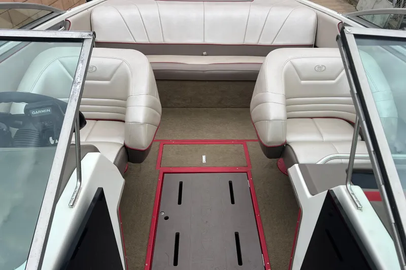 Slide: The Image of Interior of a 1996 Cobalt 220 boat with white seating and red accents. - 17
