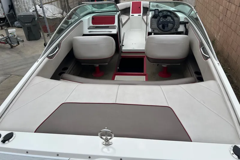Slide: The Image of 1996 Cobalt 220 boat interior with white and red seating, steering wheel, and dashboard. - 19