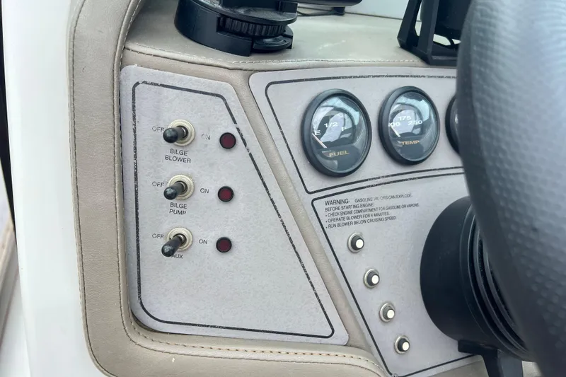 Slide: The Image of Control panel of a 1996 Cobalt 220 boat with switches and gauges. - 21