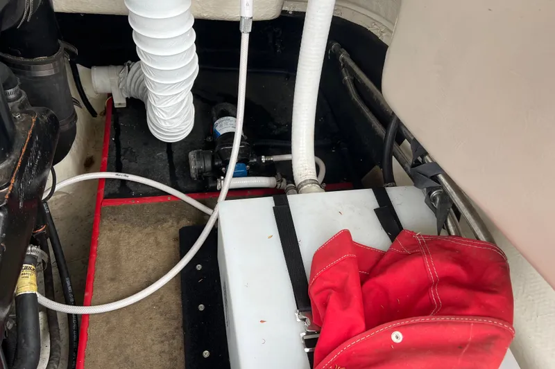 Slide: The Image of Open storage compartment on 1996 Cobalt 220 boat with coiled rope inside. - 22