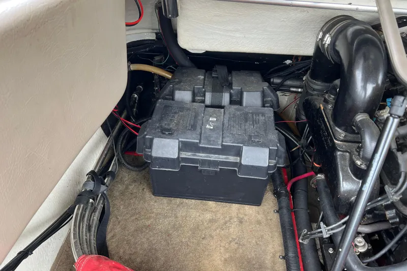 Slide: The Image of Engine compartment of a 1996 Cobalt 220 boat, showing mechanical components and hoses. - 23