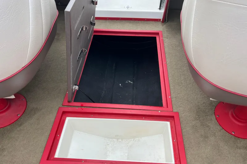 Slide: The Image of Red and white 1996 Cobalt 220 boat on trailer, parked on a concrete path. - 26