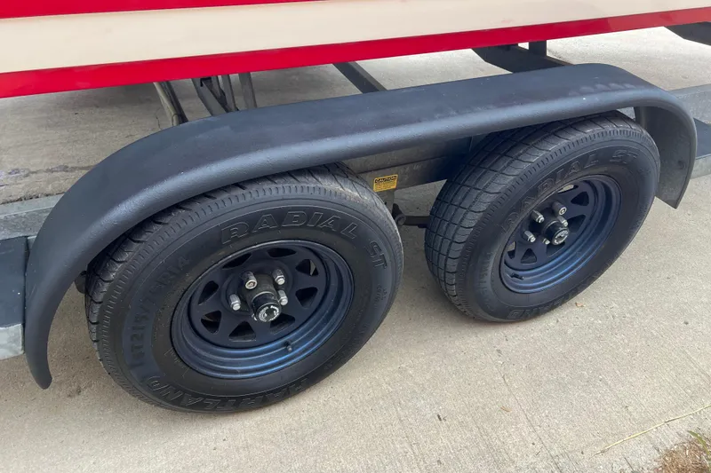 Slide: The Image of Interior of a 1996 Cobalt 220 boat with beige upholstery and red accents. - 29