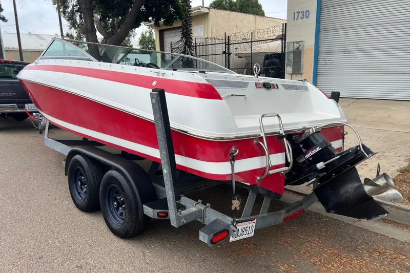 Slide: The Image of Red and white 1996 Cobalt 220 boat on trailer, parked outdoors. - 34