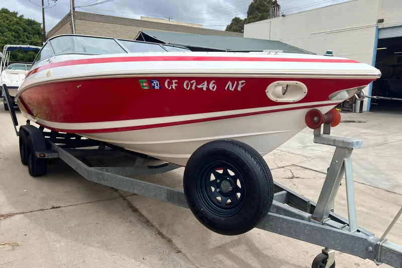 Slide: The Image of Rear view of a 1996 Cobalt 220 boat on a trailer, showcasing its red and white design. - 5