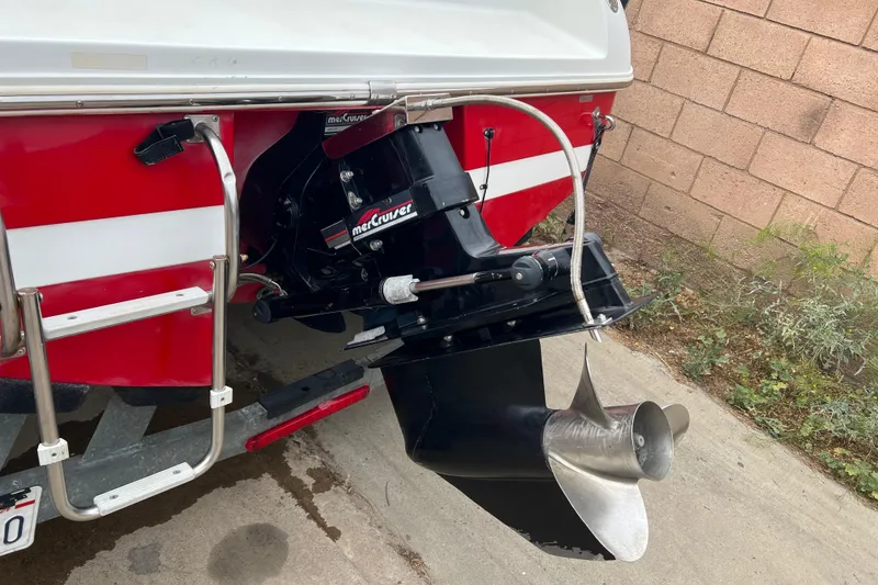 Slide: The Image of 1996 Cobalt 220 boat on trailer, red and white design, parked outdoors. - 7