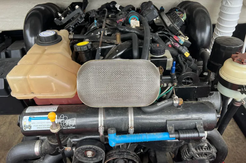 Slide: The Image of 1996 Cobalt 220 boat with red and white interior, parked on a trailer. - 8