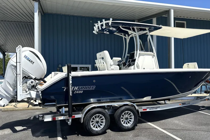 The Image of 2026 Pathfinder 2400 TRS boat with Yamaha engine on trailer, parked outdoors. - 0