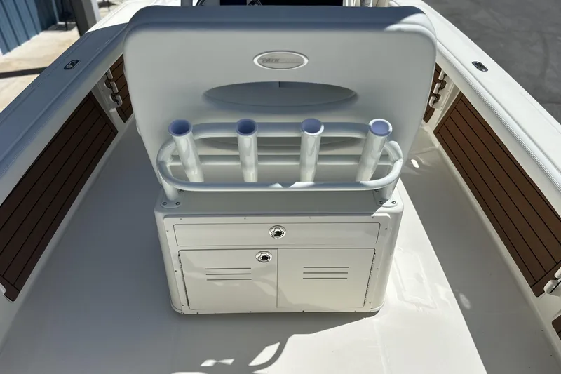 Slide: The Image of 2026 Pathfinder 2400 TRS boat interior with rod holders and storage compartments. - 11