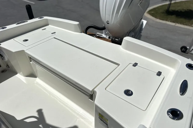 Slide: The Image of 2026 Pathfinder 2400 TRS boat deck with storage compartments and motor. - 12