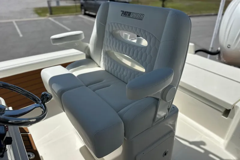 Slide: The Image of Captain's chair on 2026 Pathfinder 2400 TRS boat, featuring white cushioned seating. - 13