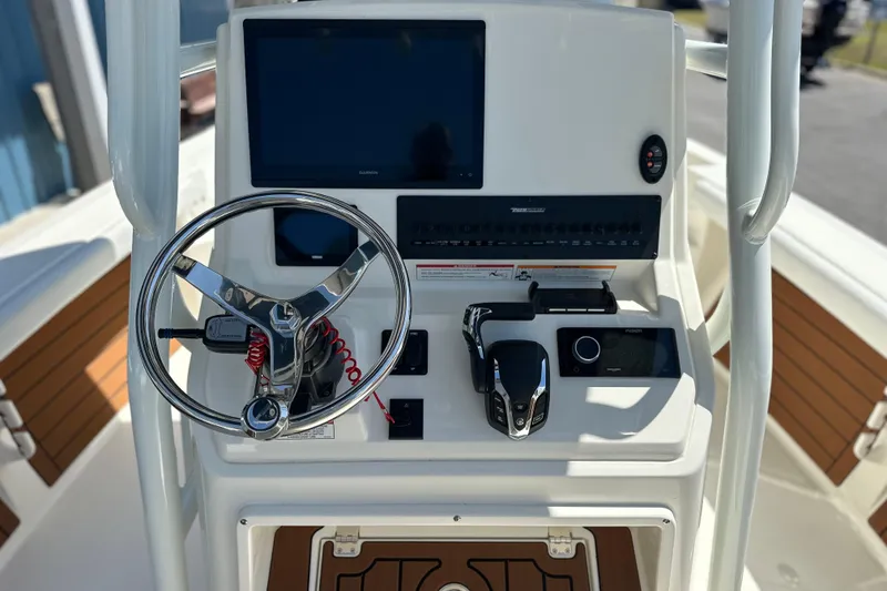 Slide: The Image of 2026 Pathfinder 2400 TRS boat dashboard with steering wheel and navigation controls. - 14