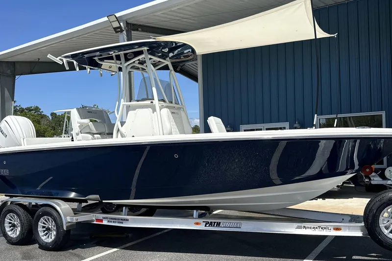 Slide: The Image of 2026 Pathfinder 2400 TRS boat on trailer under shelter, side view. - 17