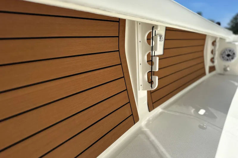 Slide: The Image of Interior view of 2026 Pathfinder 2400 TRS boat with wood paneling and rod holders. - 21