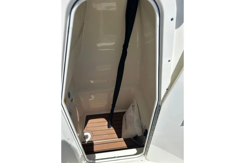 Slide: The Image of Interior view of 2026 Pathfinder 2400 TRS boat compartment with wooden flooring. - 24