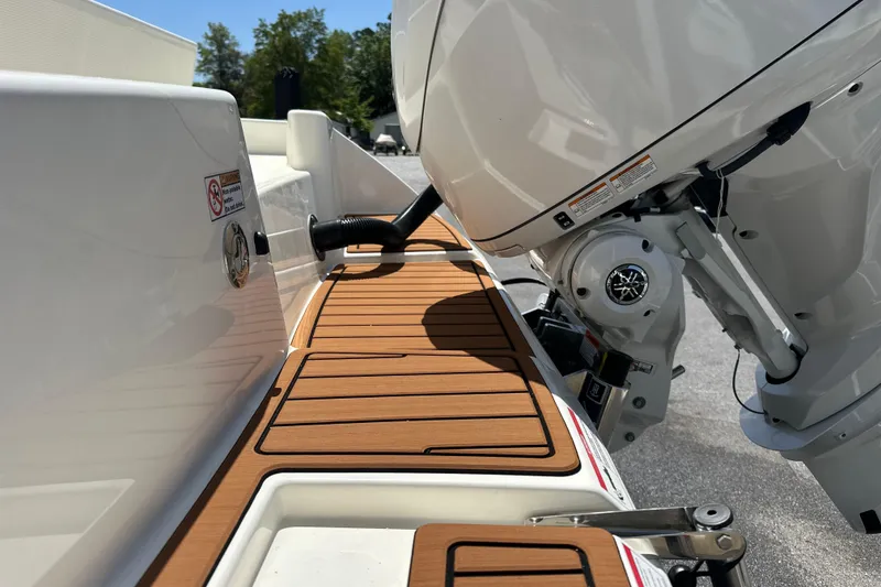 Slide: The Image of 2026 Pathfinder 2400 TRS boat with teak deck and powerful outboard motor. - 4