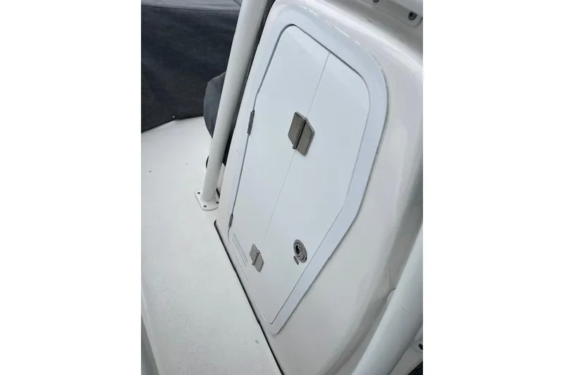 Slide: The Image of 2024 Sea Fox 248 Commander boat storage compartment with secure latch. - 10