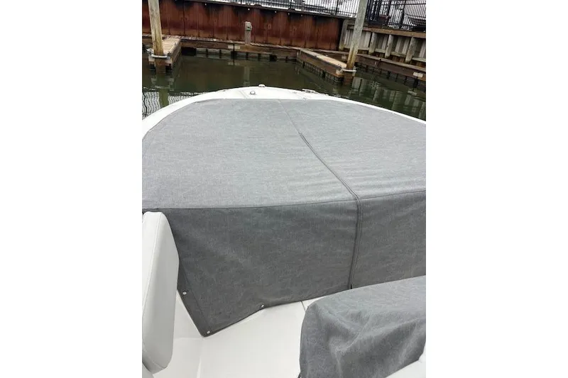 Slide: The Image of 2024 Sea Fox 248 Commander boat with gray cover at dock. - 11