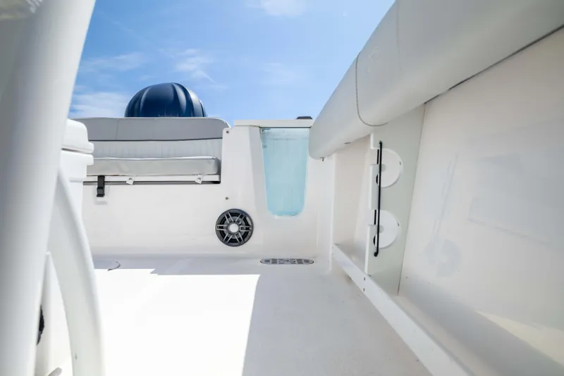 Slide: The Image of 2024 Sea Fox 248 Commander boat interior with seating and speaker, under clear blue sky. - 19