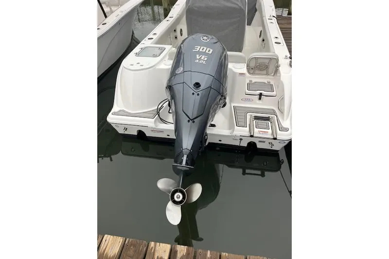 Slide: The Image of 2024 Sea Fox 248 Commander with Yamaha 300 V6 outboard engine at dock. - 2
