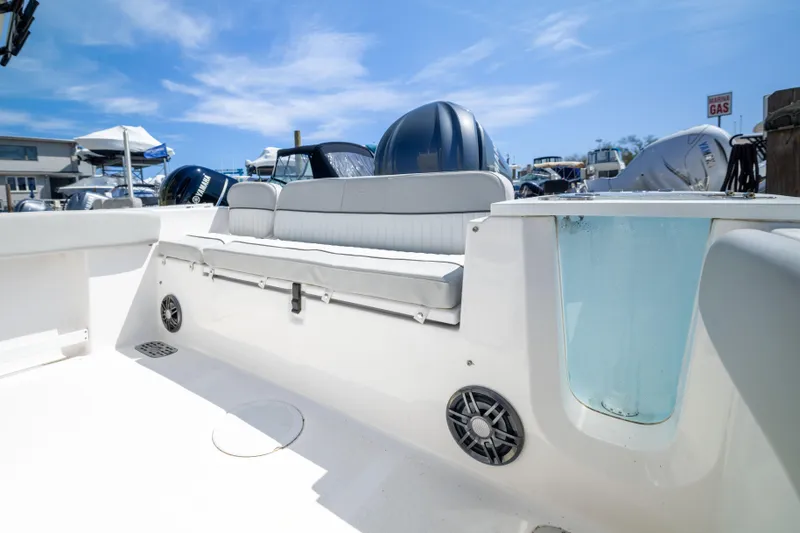 Slide: The Image of 2024 Sea Fox 248 Commander boat interior with seating and speaker, under clear blue sky. - 20