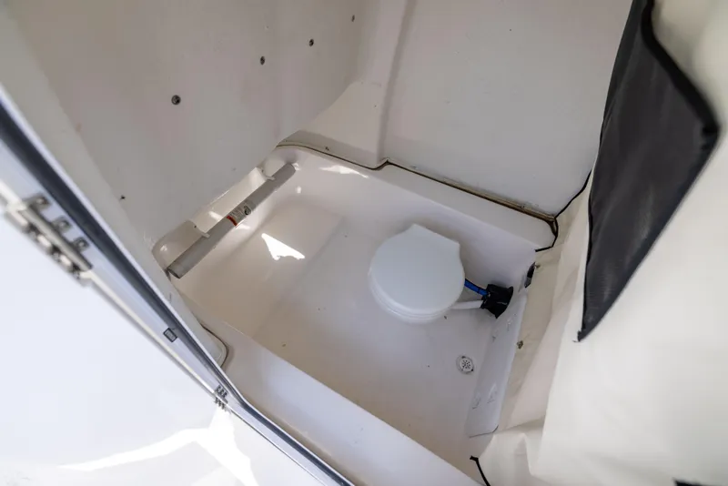 Slide: The Image of 2024 Sea Fox 248 Commander boat interior with compact marine toilet. - 24