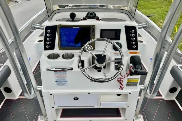 Slide: The Image of 2015 Robalo 226 Cayman boat dashboard with steering wheel and navigation system. - 10